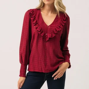 La blouse en dentelle col en V à volant